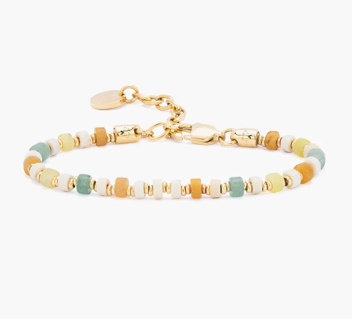 Multicolored beaded bracelet with gold chain on a white background