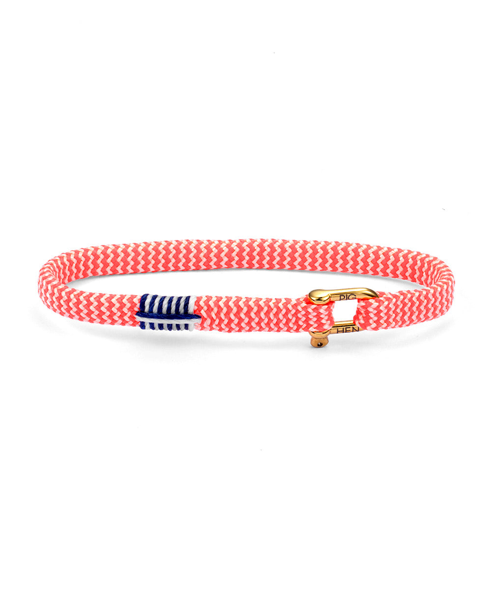 Red woven bracelet with a gold clasp and blue and white striped tag on a white background