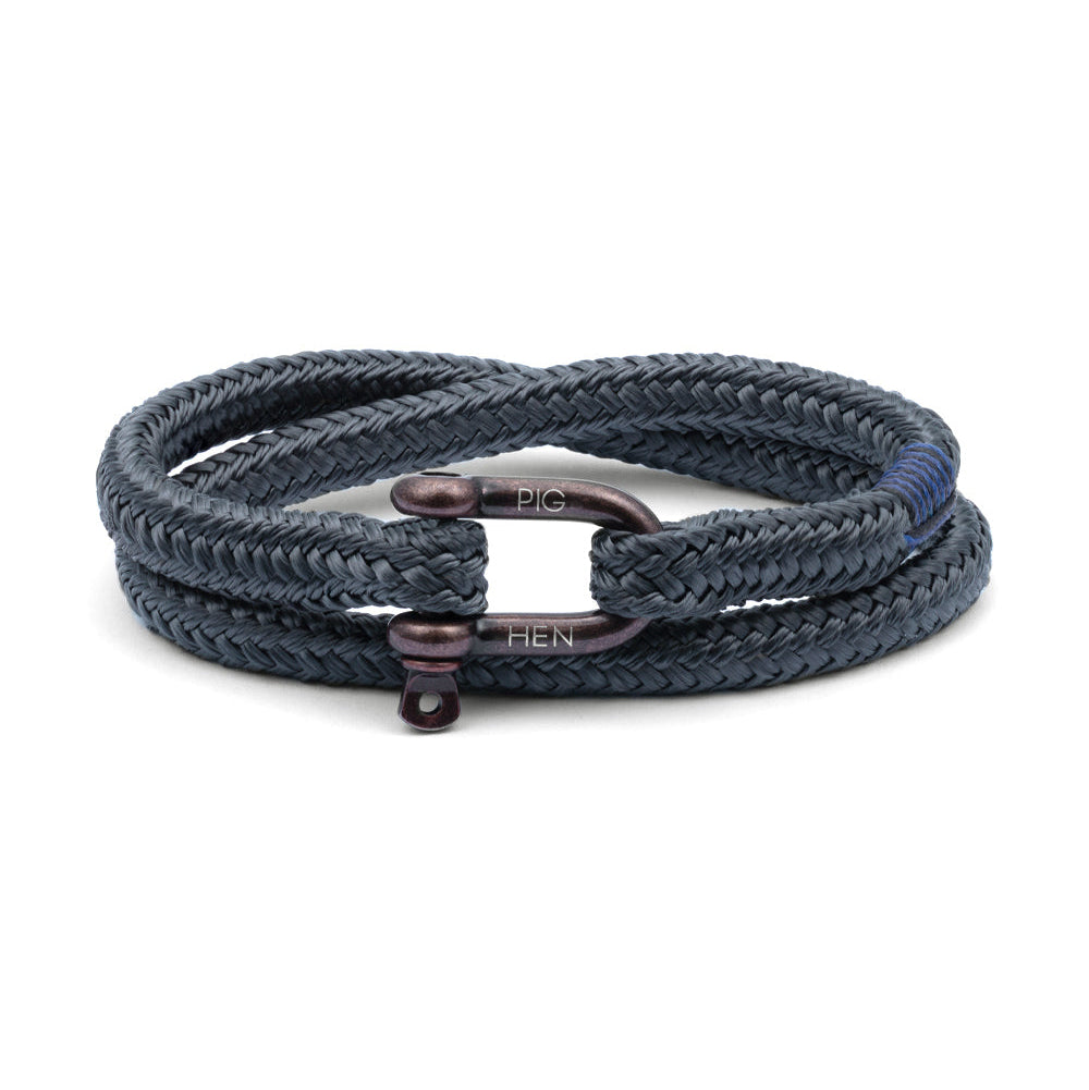 Navy braided bracelet with bronze clasp on a white background