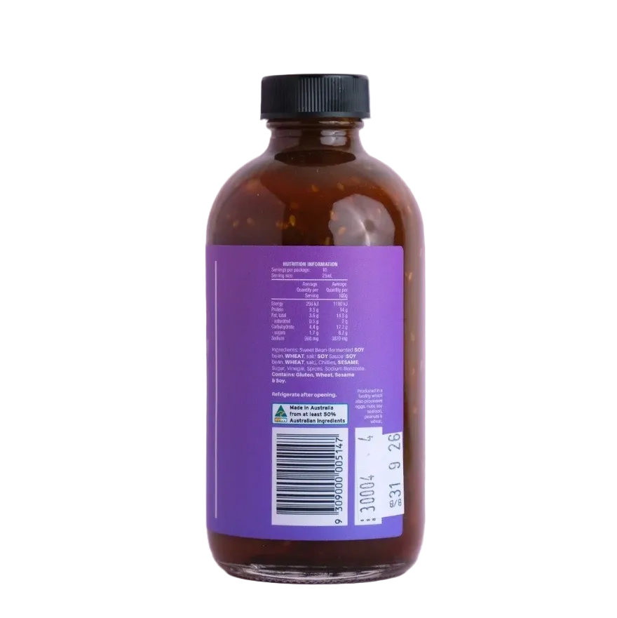 Brown glass bottle with a purple label on a light pink background