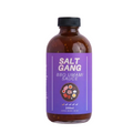 Bottle of Salt Gang BBQ Umami Sauce on a light purple background