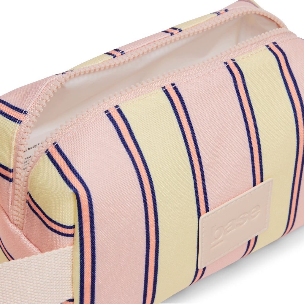 Striped pouch with pink, yellow, and blue pattern on a white background