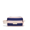 Navy and pink striped toiletry bag with beige tag on a white background