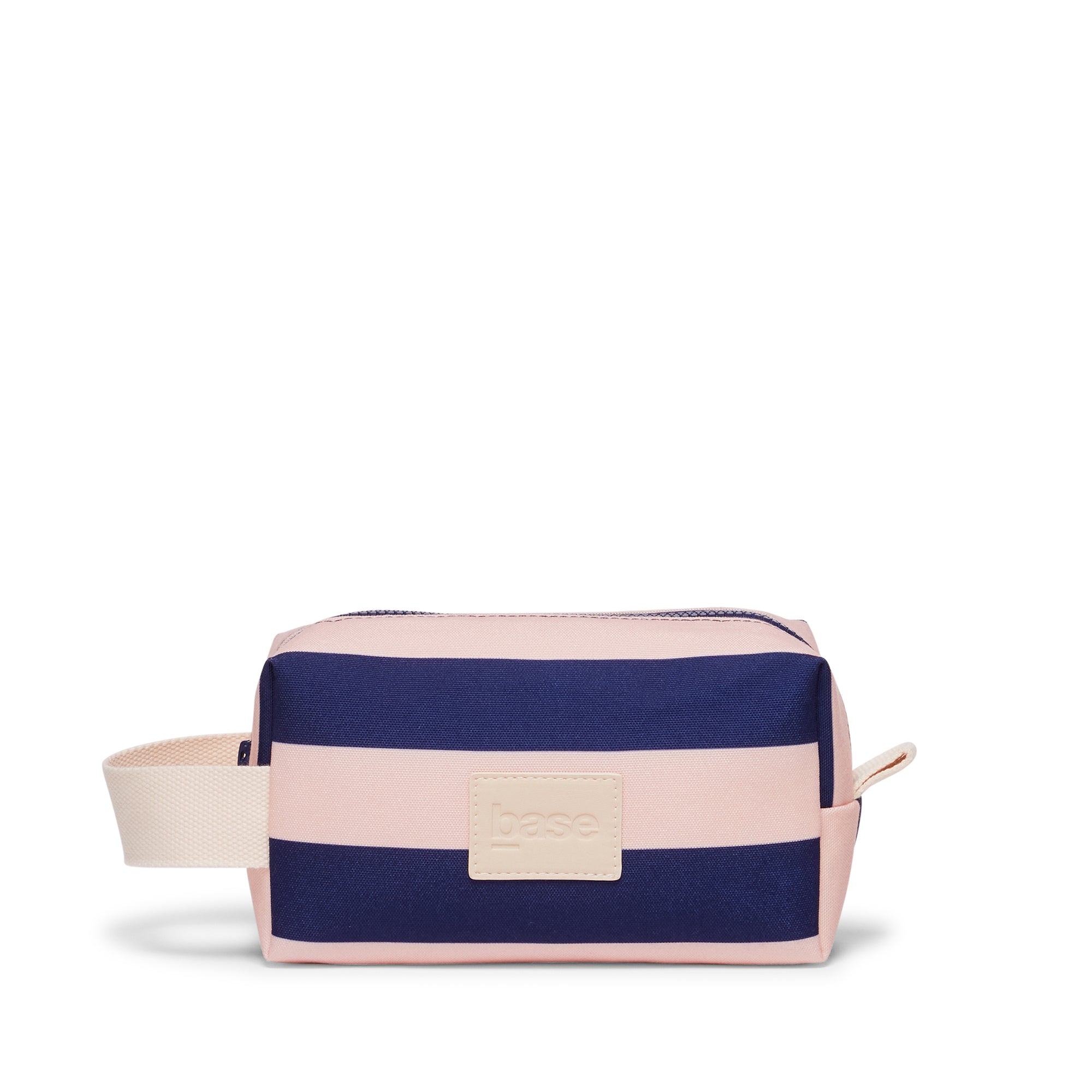 Navy and pink striped toiletry bag with beige tag on a white background