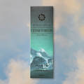 Himalayan Cedar Forests incense packaging with mountain design on a soft focus background